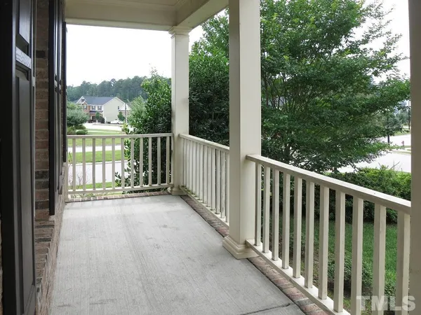 a view of a wooden deck next to a yard