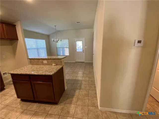 a view of a kitchen cabinets and a counter place