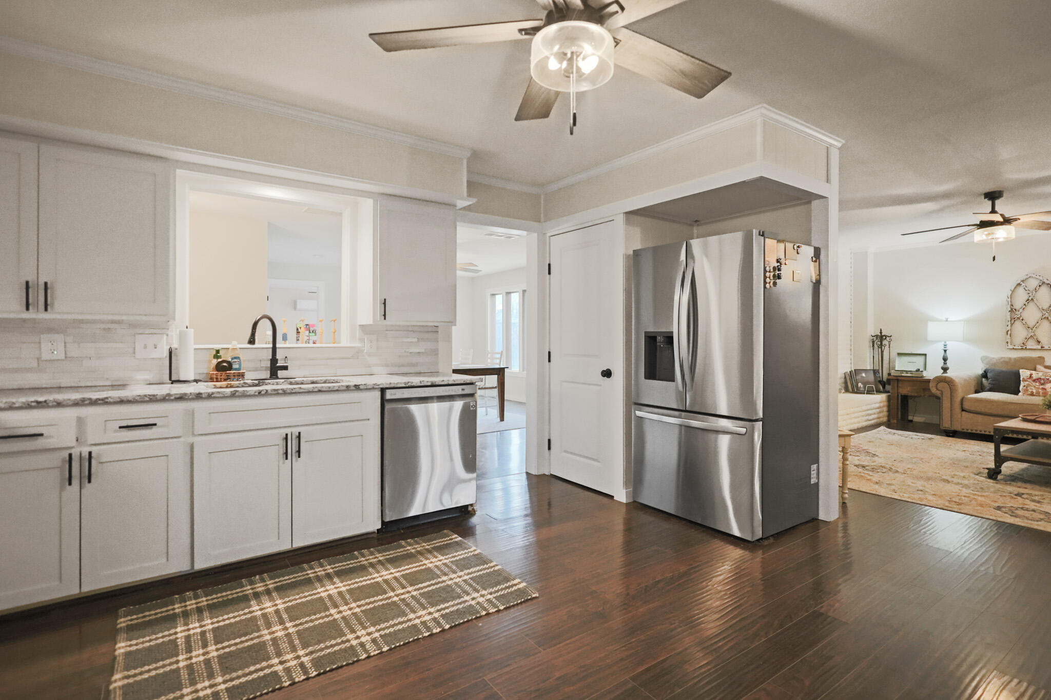 4302 42nd Street Lubbock, TX 79413 - Photo 13 of 67 a kitchen with a refrigerator a sink cabinets and wooden floor