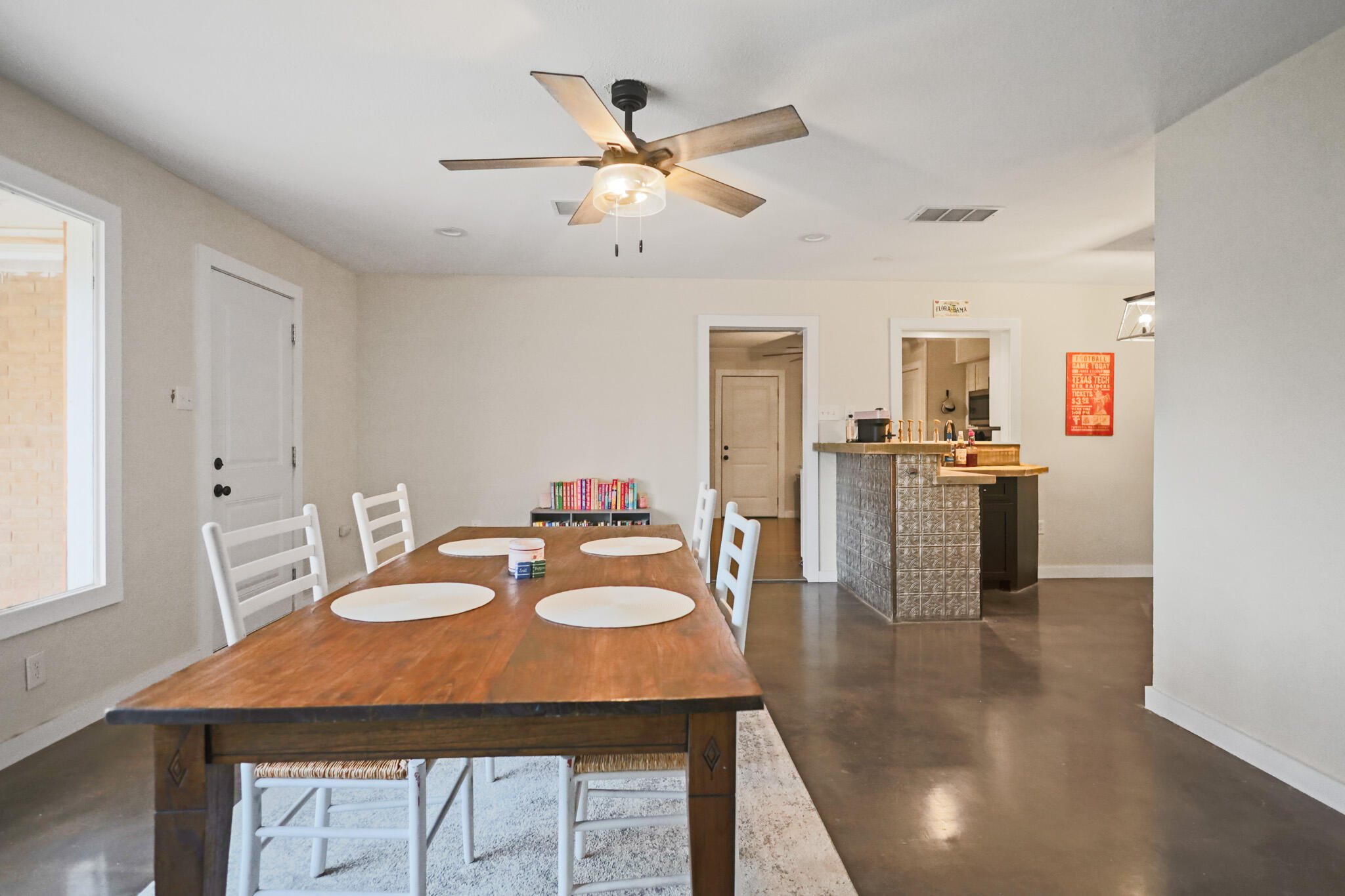 4302 42nd Street Lubbock, TX 79413 - Photo 24 of 67 a dining room with furniture and a kitchen view