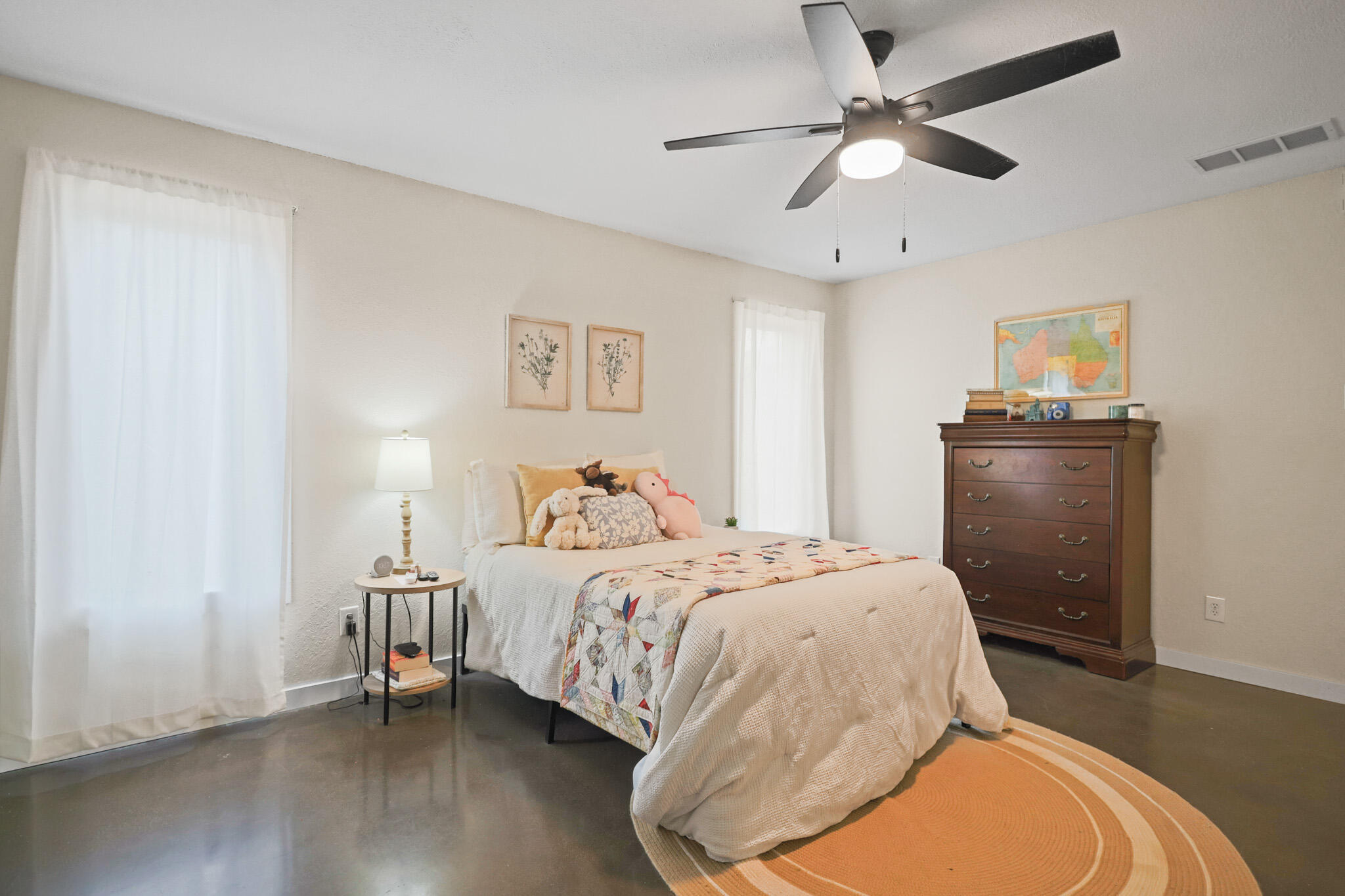 4302 42nd Street Lubbock, TX 79413 - Photo 33 of 67 a bedroom with a bed and a chandelier