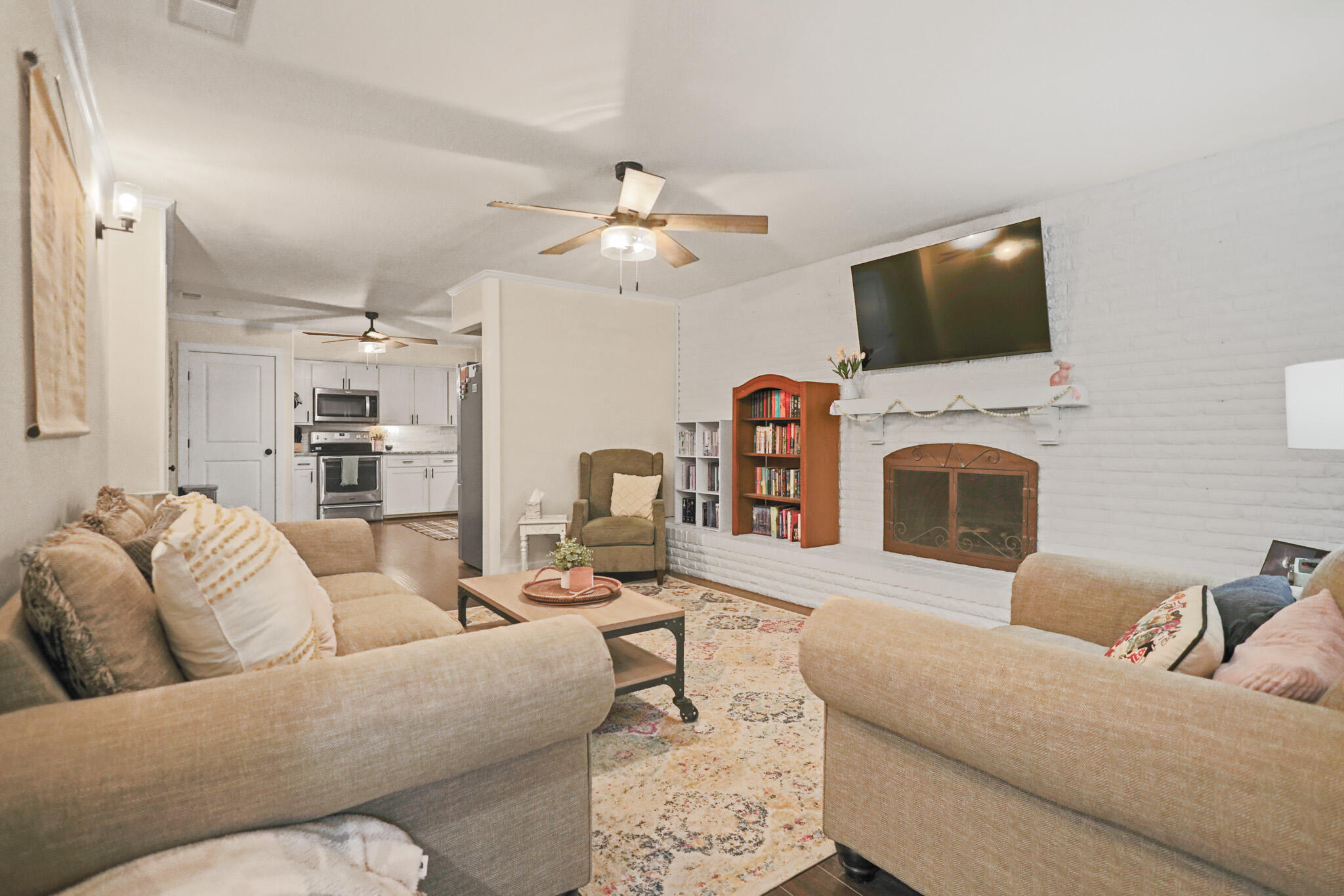 4302 42nd Street Lubbock, TX 79413 - Photo 4 of 67 a living room with furniture a flat screen tv and a fireplace