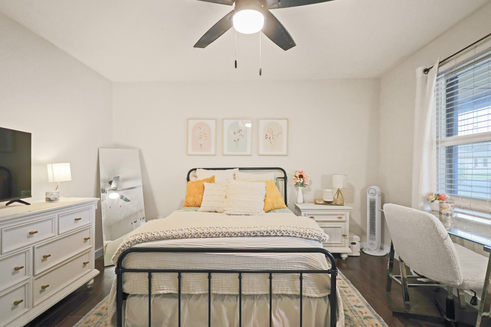 4302 42nd Street Lubbock, TX 79413 - Photo 43 of 67 a bedroom with a bed a chandelier and a dresser