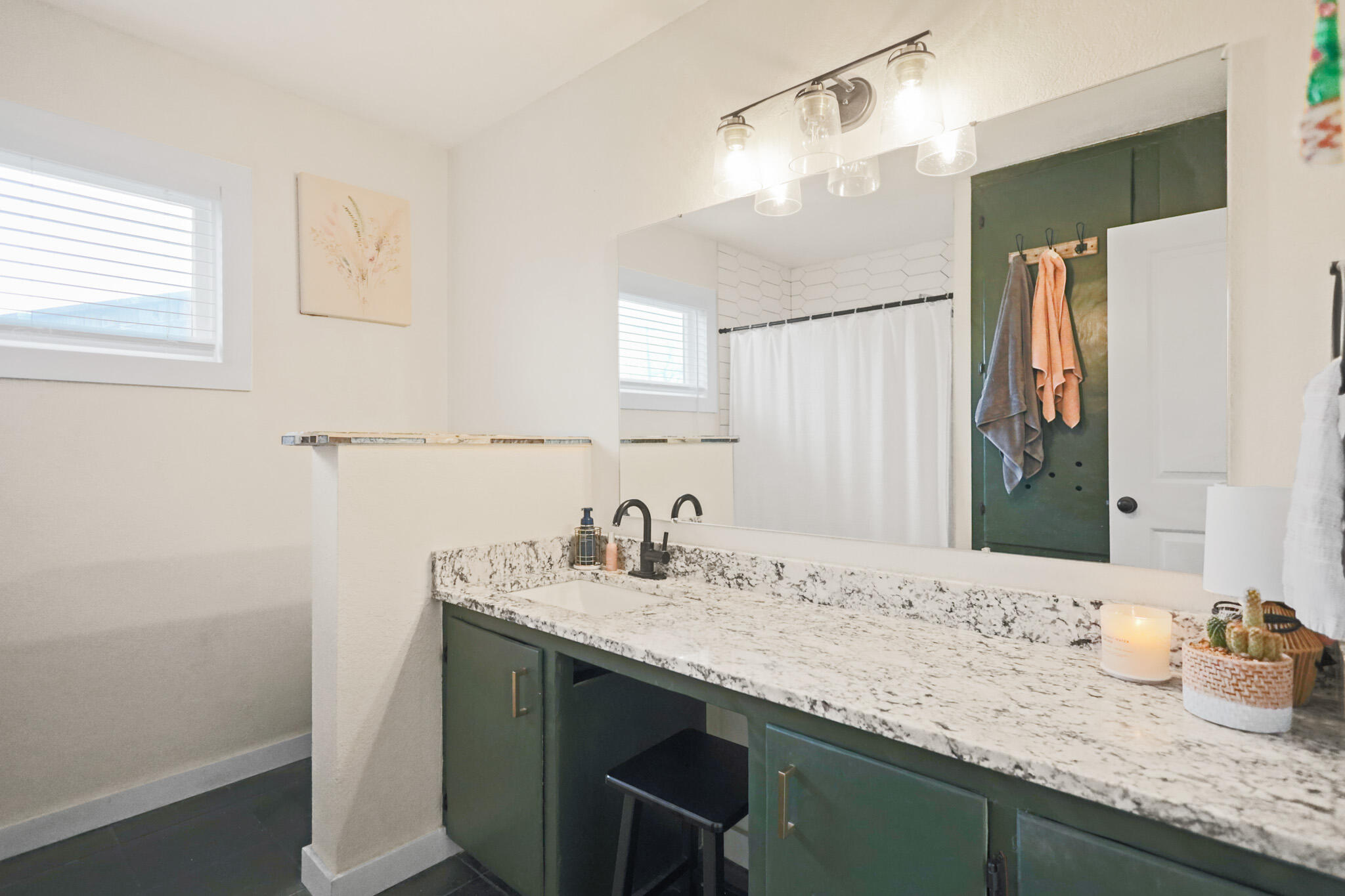 4302 42nd Street Lubbock, TX 79413 - Photo 51 of 67 a bathroom with a sink and a mirror