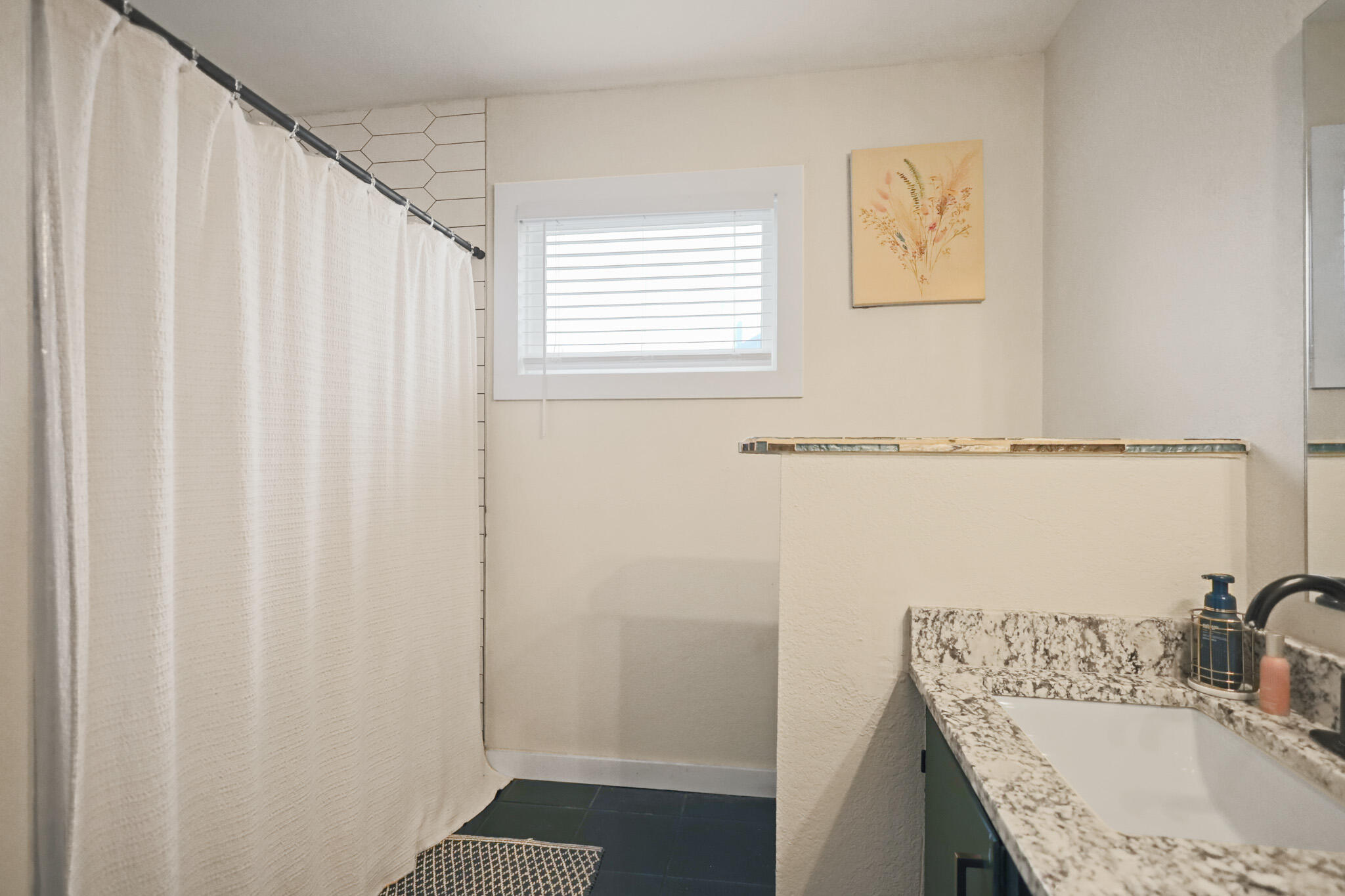 4302 42nd Street Lubbock, TX 79413 - Photo 53 of 67 a bathroom with a granite countertop sink and a shower