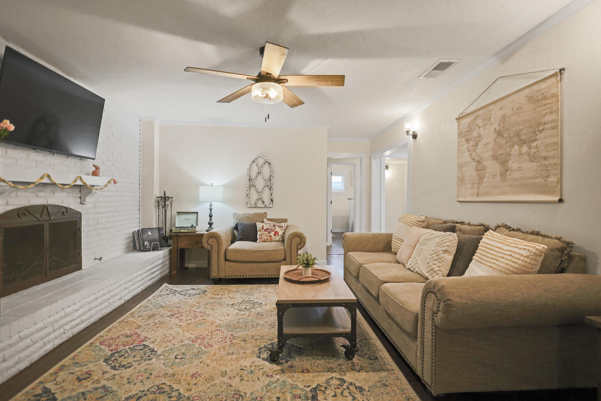 4302 42nd Street Lubbock, TX 79413 - Photo 8 of 67 a living room with furniture a fireplace and a flat screen tv