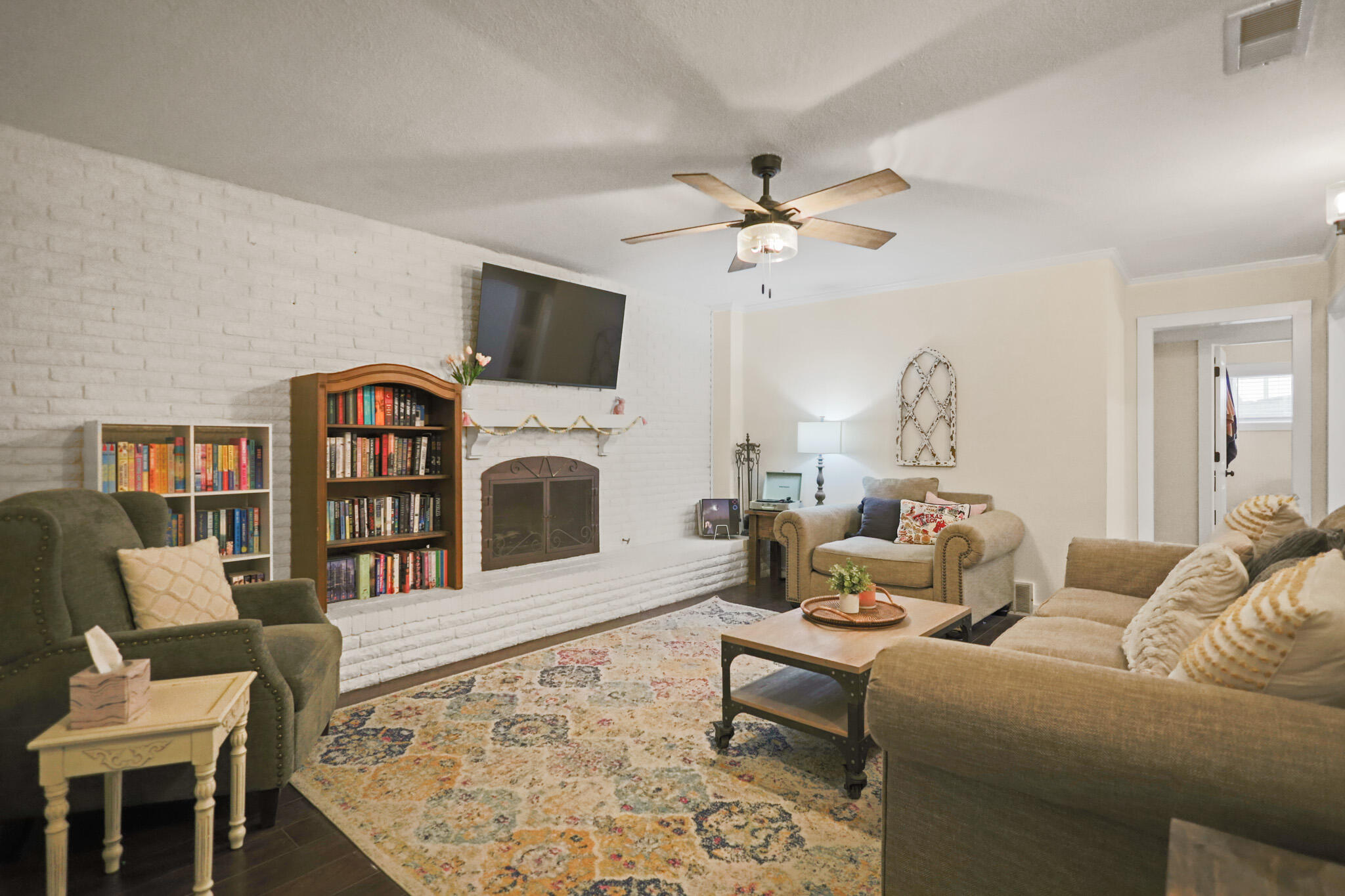 4302 42nd Street Lubbock, TX 79413 - Photo 9 of 67 a living room with furniture a fireplace and a flat screen tv