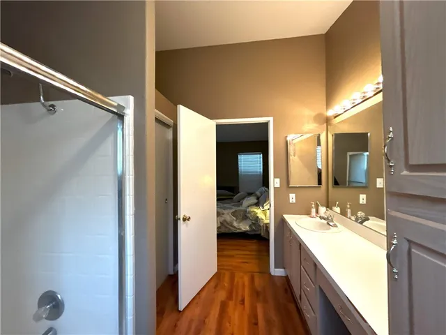 a bedroom with two beds and a chair