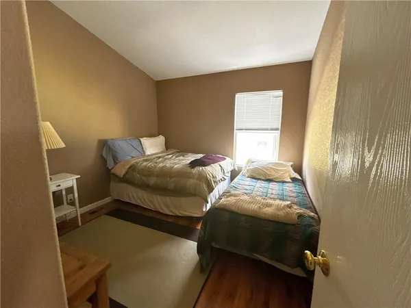 a bedroom with two beds and a window