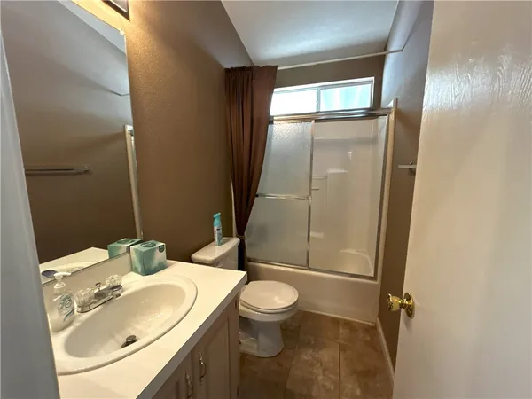 a bedroom with a bed and a night stand