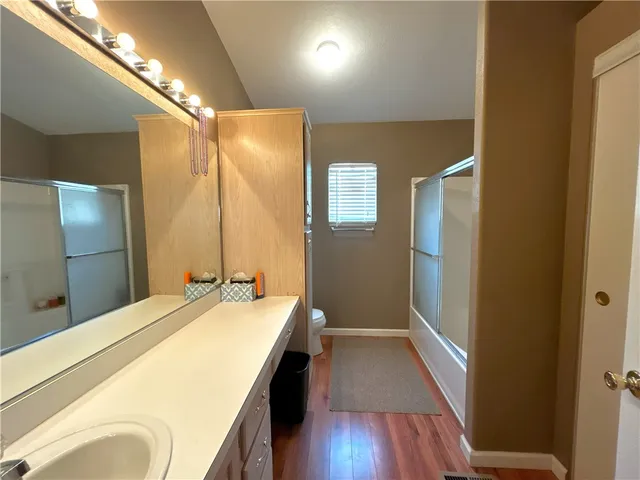 a spacious bathroom with a double vanity sink and a mirror