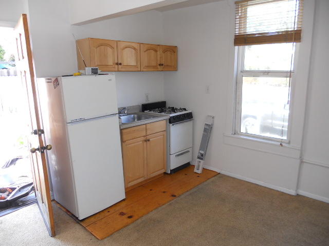 703 Castillo Street, Unit 2 Santa Barbara, CA 93101 - Photo 4 of 8 a room with a refrigerator and window