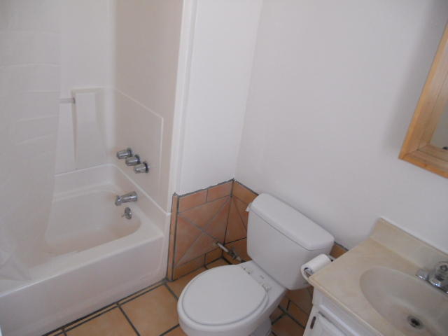 703 Castillo Street, Unit 2 Santa Barbara, CA 93101 - Photo 8 of 8 a white toilet and tub sitting next to a bathroom sink