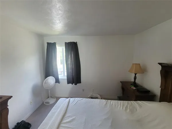 a bedroom with a bed and window