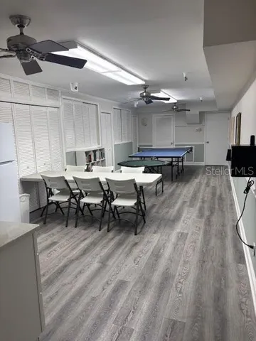 a view of a hallway with closet and wooden floor