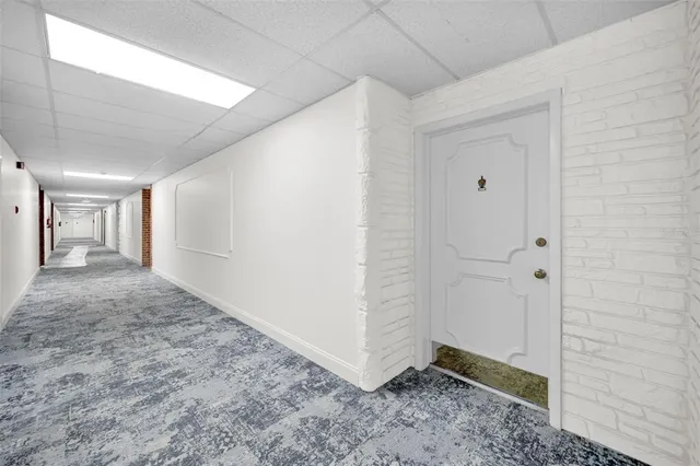 a kitchen with granite countertop white cabinets and stainless steel appliances