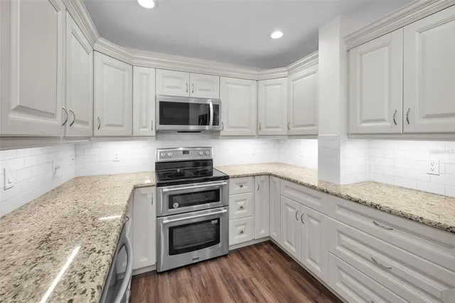 a view of a dining room with furniture wooden floor and chandelier