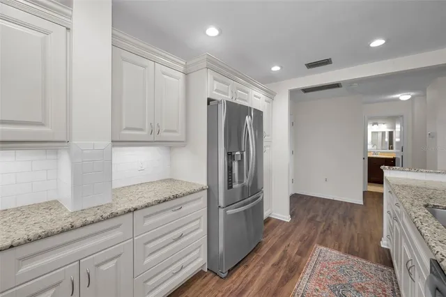 a dining room with furniture a chandelier and wooden floor