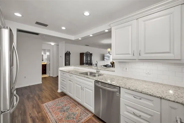 a dining room with wooden floor a chandelier a wooden table and chairs
