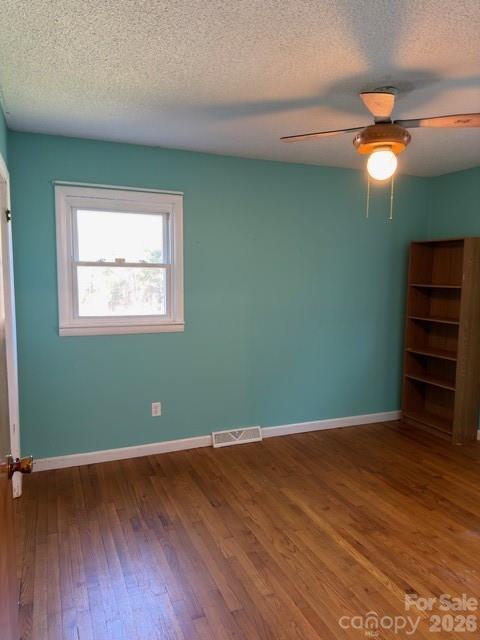 5376 Rhoney Road Connelly Springs, NC 28612 - Photo 12 of 21 an empty room with wooden floor closet and windows
