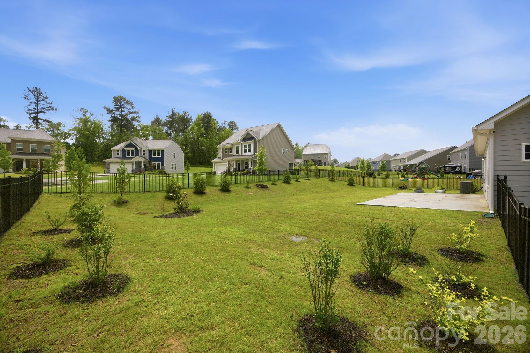 234 Hamptons Cove Road Troutman, NC 28166 - Photo 25 of 32 a view of a lake with a houses