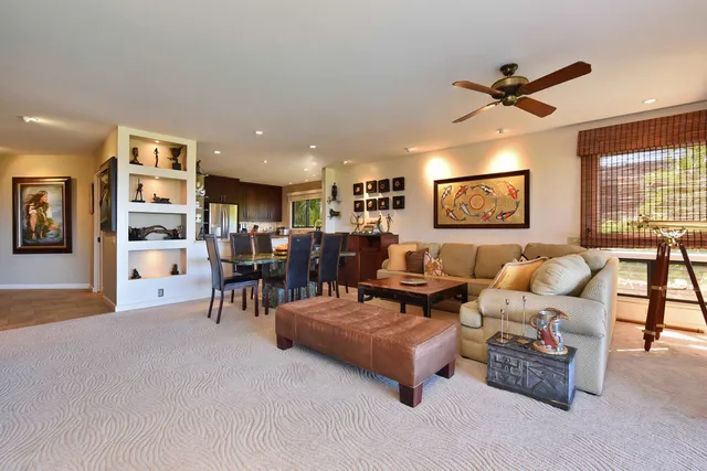 a living room with furniture and a ceiling fan