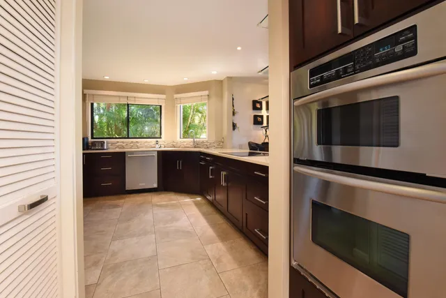 a kitchen with a sink refrigerator and window