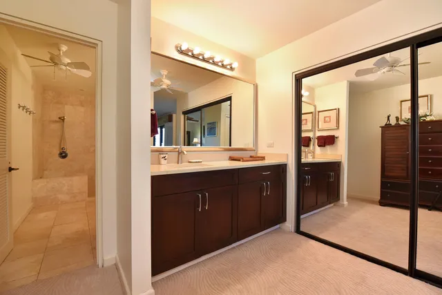a bathroom with a tub sink and mirror