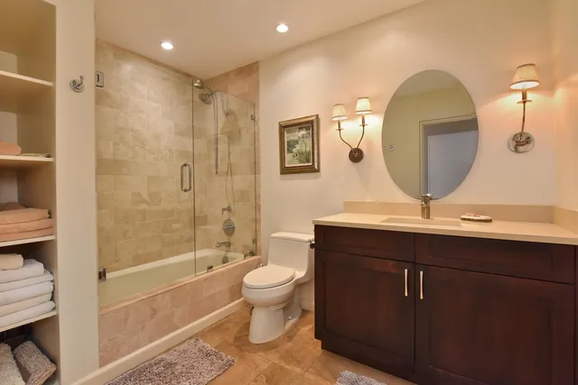 a bedroom with a bed painting on wall and a large window