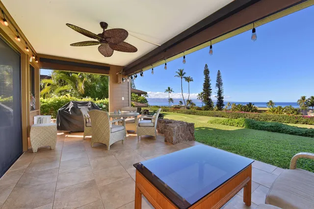 a view of a patio with table and chairs potted plants with sky view