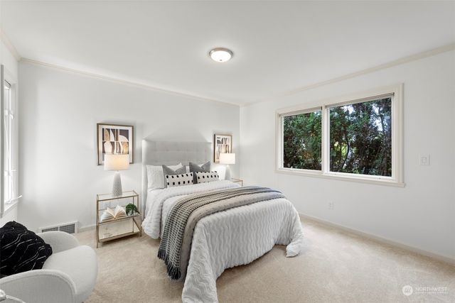 a bedroom with a bed and a large window
