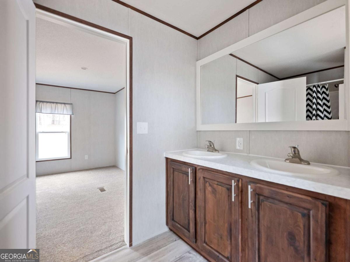 5224 Bogus Road Gainesville, GA 30506 - Photo 17 of 43 a en suite bathroom with a granite countertop sink and a mirror
