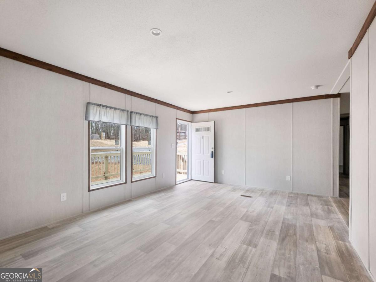 5224 Bogus Road Gainesville, GA 30506 - Photo 4 of 43 a view of an empty room with wooden floor and a window