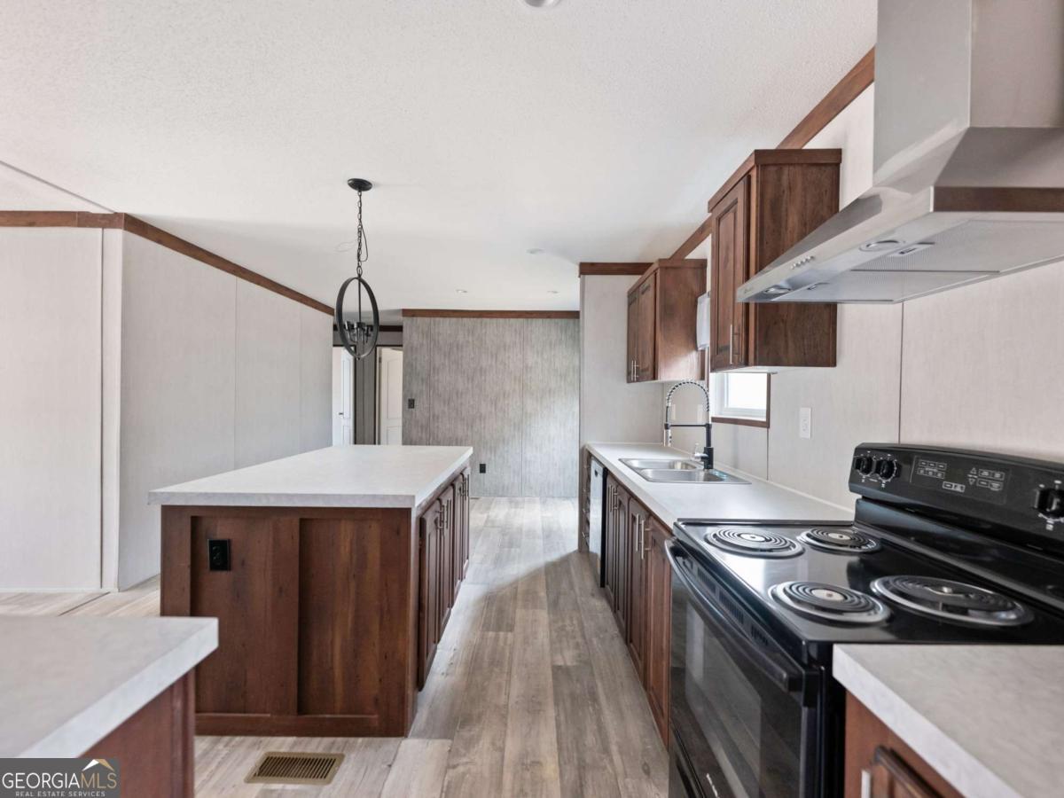 5224 Bogus Road Gainesville, GA 30506 - Photo 9 of 43 a kitchen with stainless steel appliances a sink stove and cabinets
