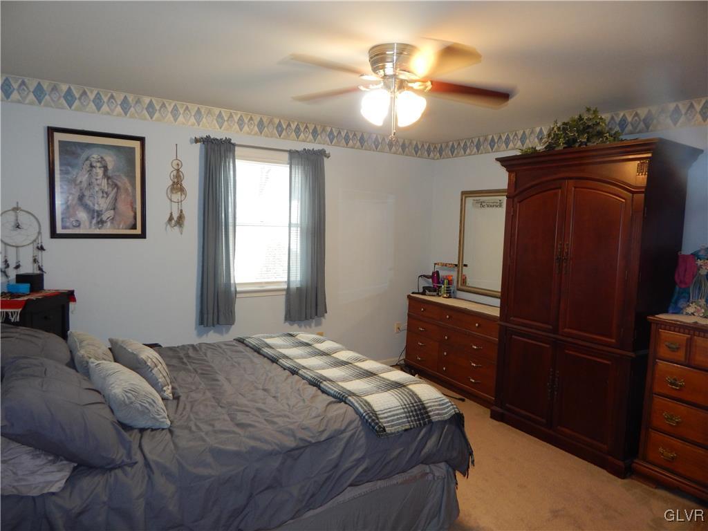 326 Chestnut Street Slatington, PA 18080 - Photo 11 of 14 a bedroom with a bed and a chandelier