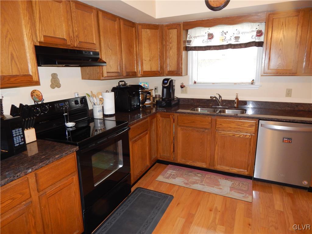 326 Chestnut Street Slatington, PA 18080 - Photo 3 of 14 a kitchen with granite countertop wooden cabinets stainless steel appliances a sink and a window