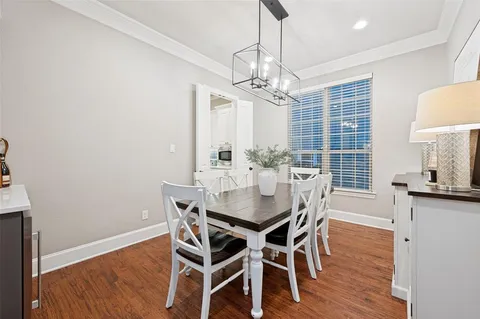 a view of a dining room with furniture wooden floor and chandelier