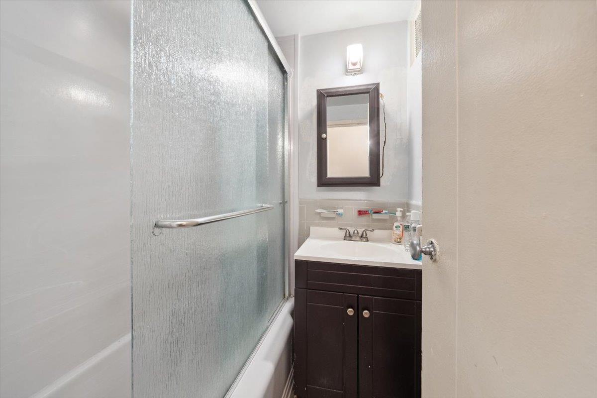 3 Fordham Hill Ovl, Unit 10B Bronx, NY 10468 - Photo 12 of 33 Full bath featuring vanity and enclosed tub / shower combo