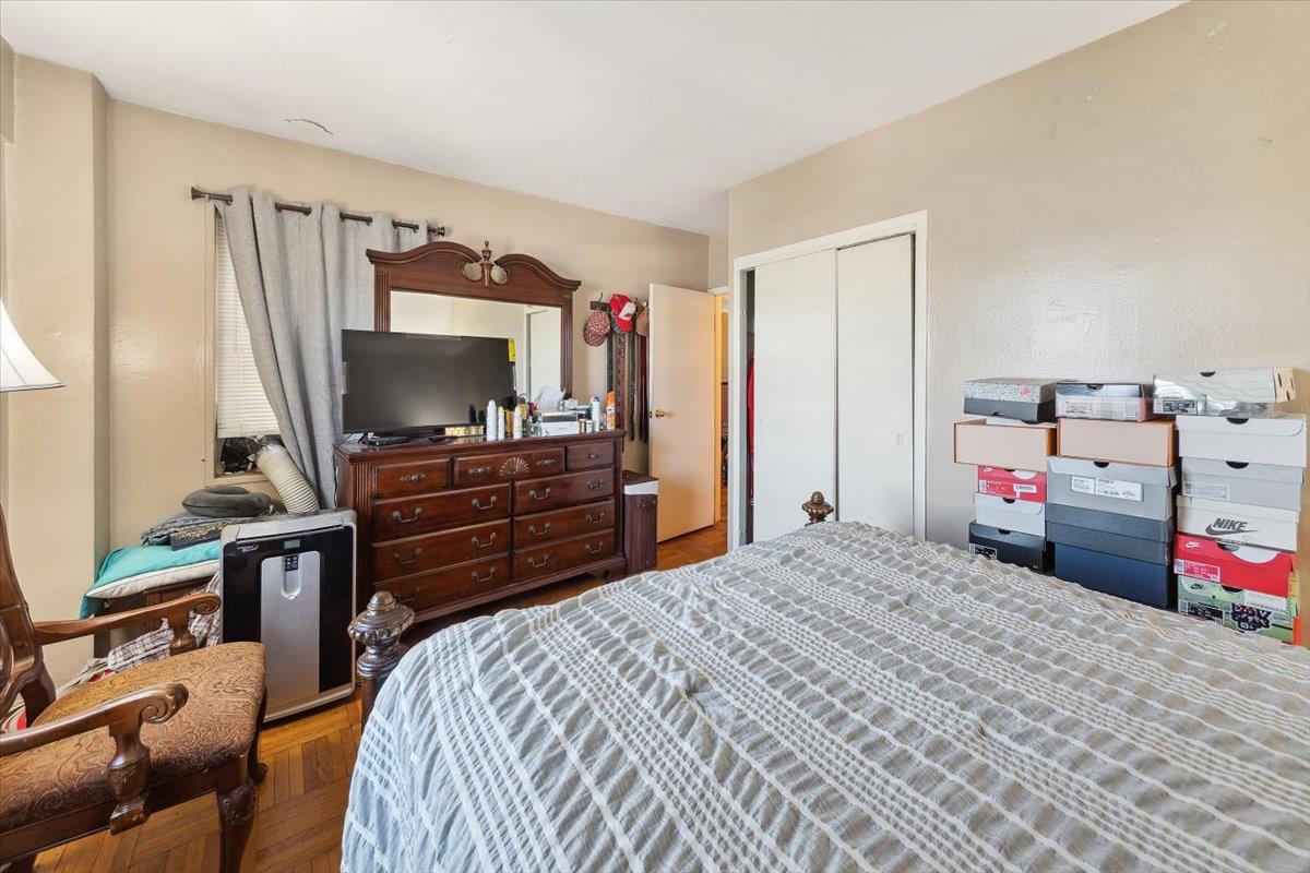 3 Fordham Hill Ovl, Unit 10B Bronx, NY 10468 - Photo 14 of 33 Bedroom with a closet and wood finished floors