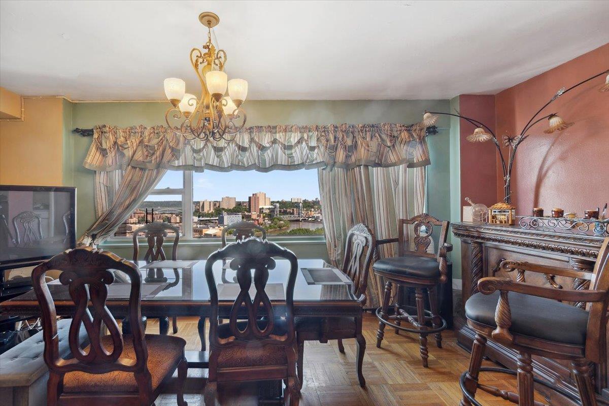 3 Fordham Hill Ovl, Unit 10B Bronx, NY 10468 - Photo 15 of 33 Dining area featuring a chandelier