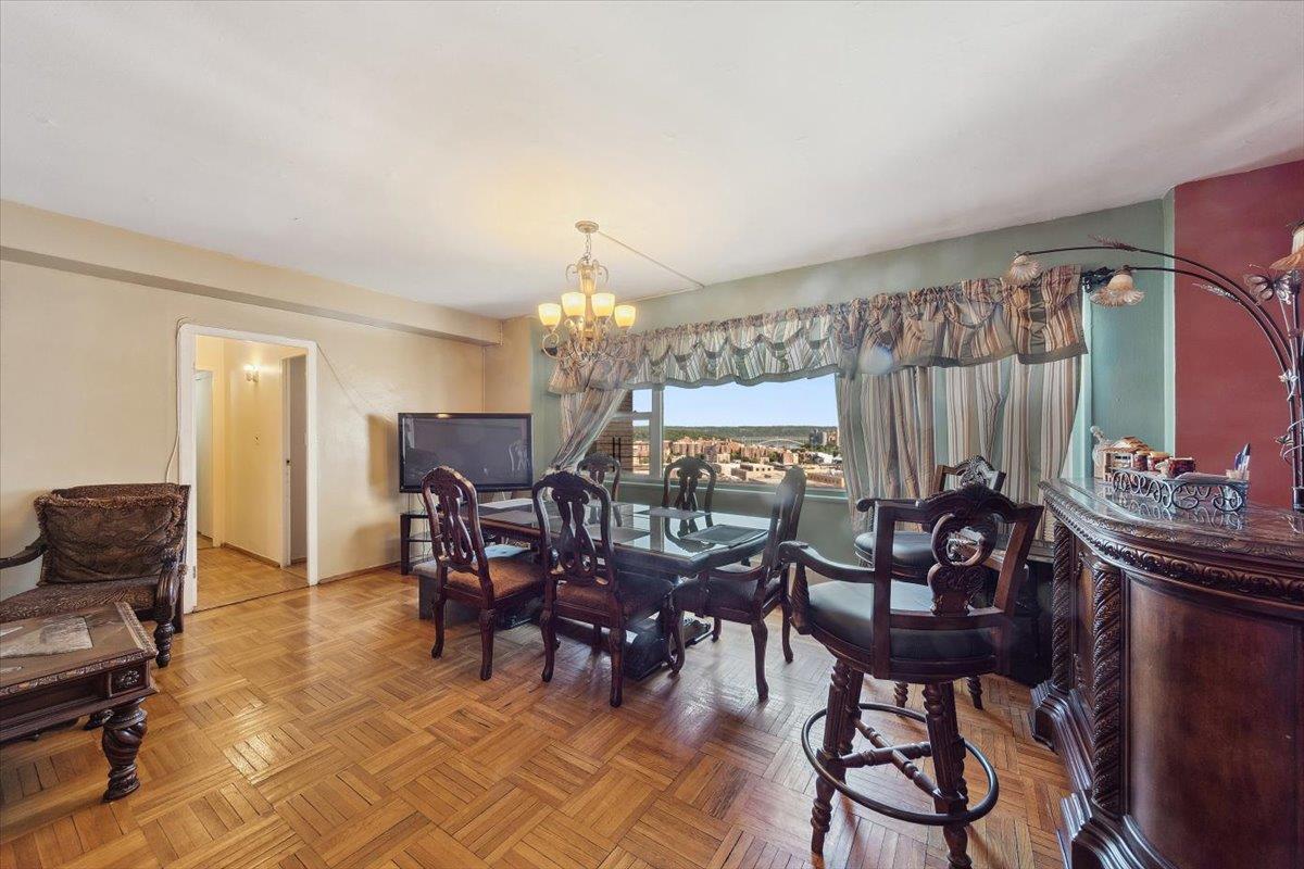 3 Fordham Hill Ovl, Unit 10B Bronx, NY 10468 - Photo 16 of 33 Dining room with a chandelier and baseboards