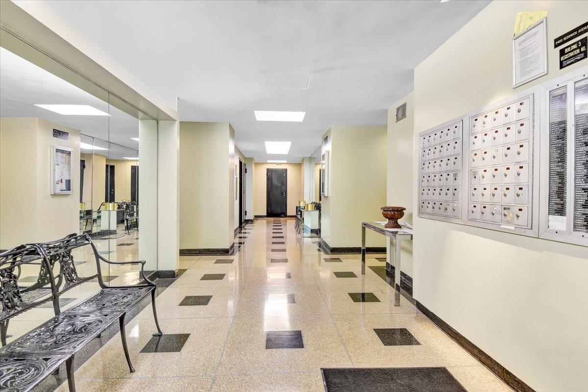 3 Fordham Hill Ovl, Unit 10B Bronx, NY 10468 - Photo 26 of 33 Hall with baseboards, granite floors, and mail area