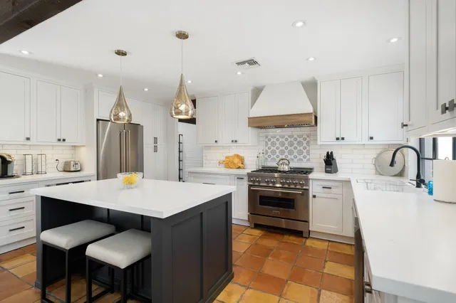 a kitchen with a sink appliances and cabinets