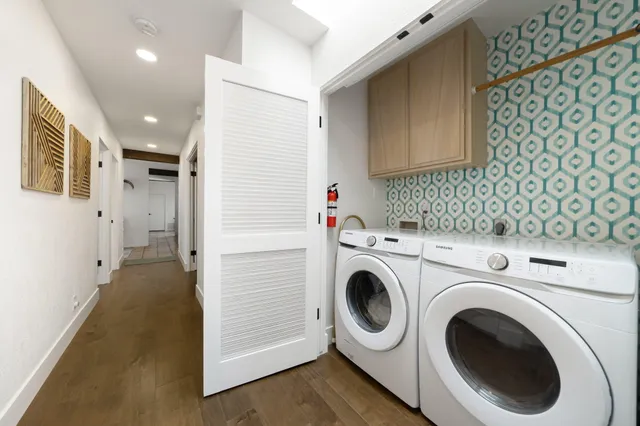 a view of a patio with a table and chairs under an umbrella