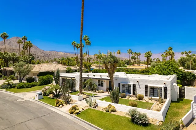 a hallway with a couch and a window