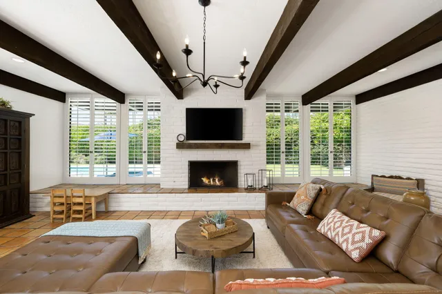 a living room with furniture and a chandelier
