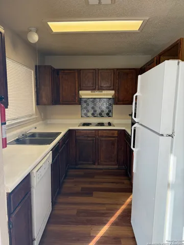 a kitchen with a refrigerator and a sink