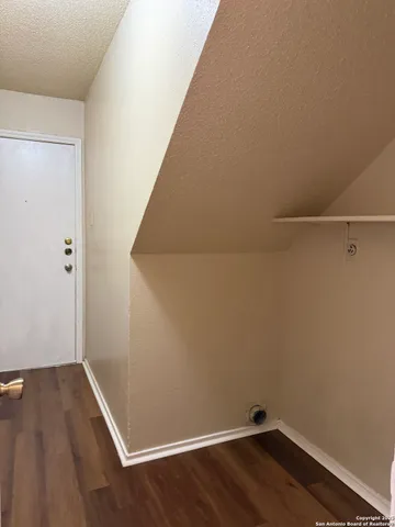 a view of a room with wooden floor