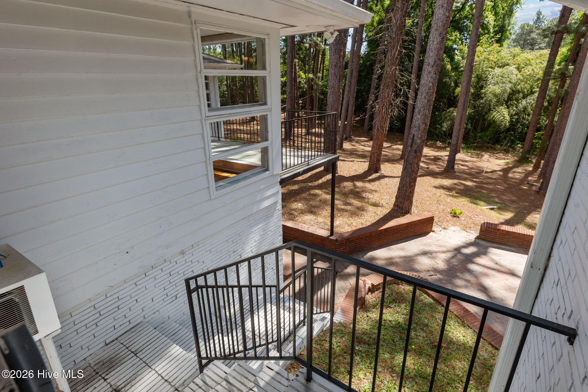 1010 Bion Butler Road Aberdeen, NC 28315 - Photo 5 of 62 Stairs flowing from den to courtyard