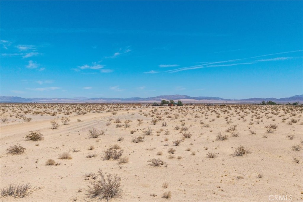 82935 Maya Rada Road Twentynine Palms, CA 92277 - Photo 12 of 30 a view of a dry yard with a mountain